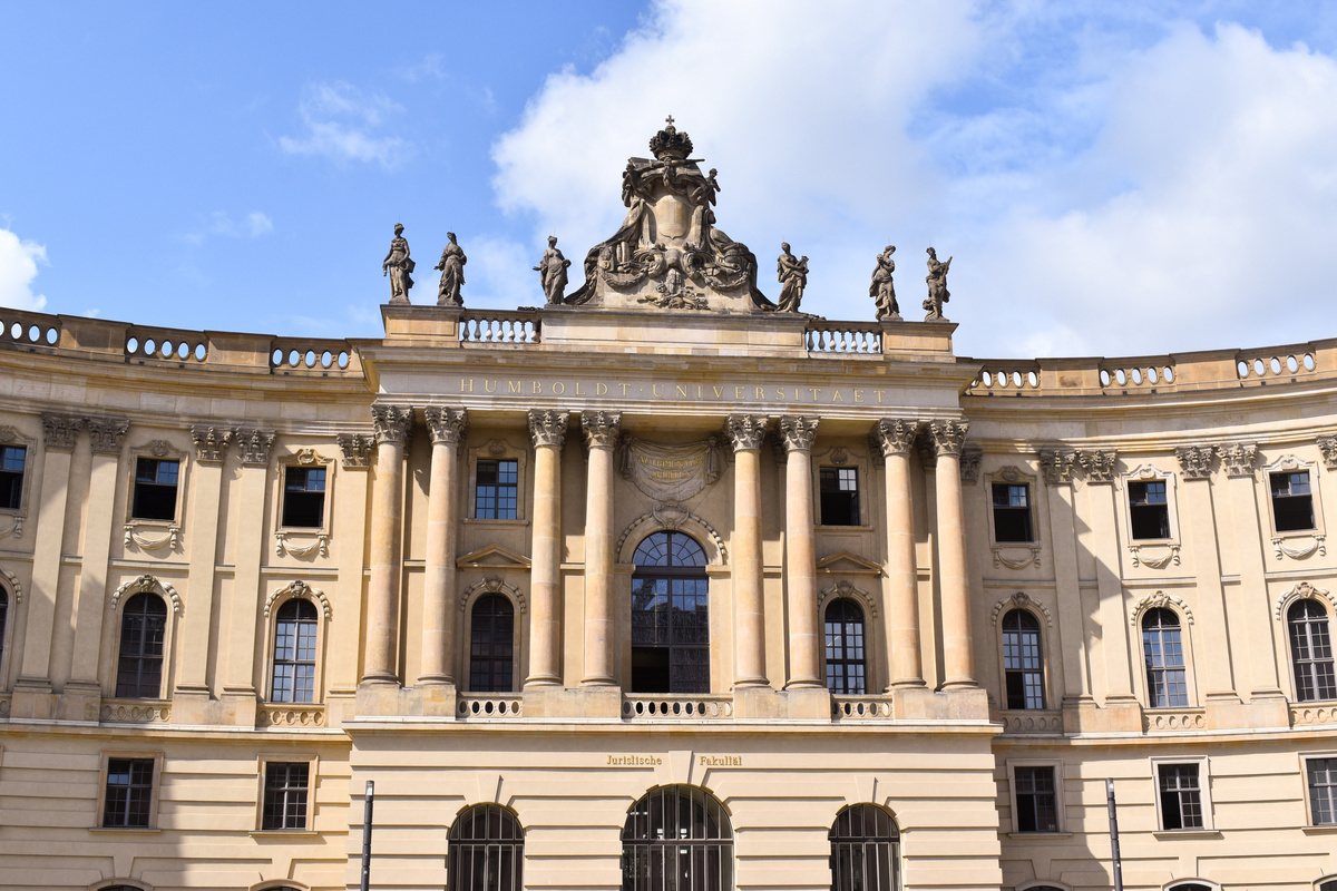 Neoclassical European university building under a clear sky